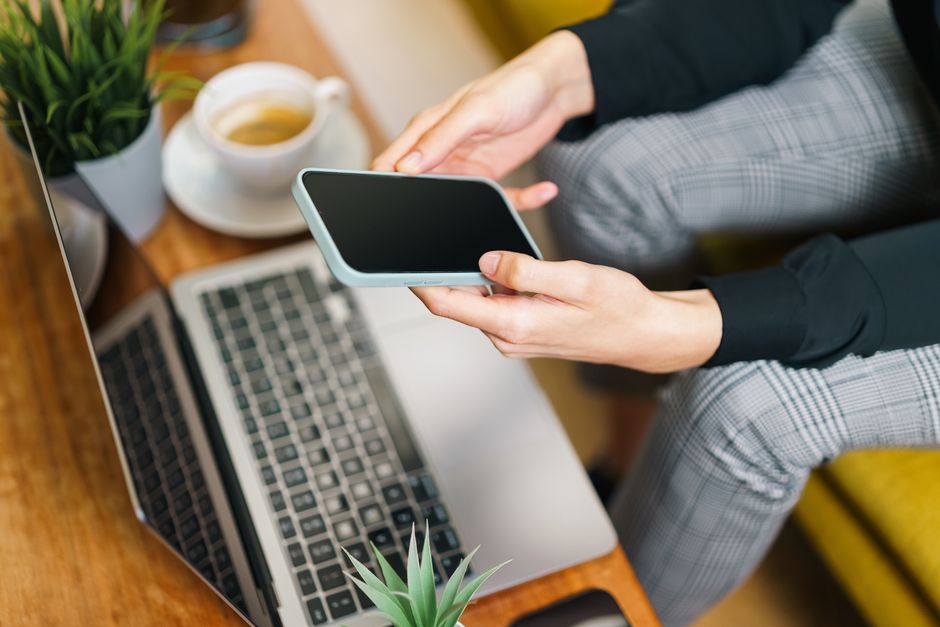 A person intently browsing high-quality, professional photos of a luxury home on a laptop, illustrating how compelling visuals are key to online real estate searches.