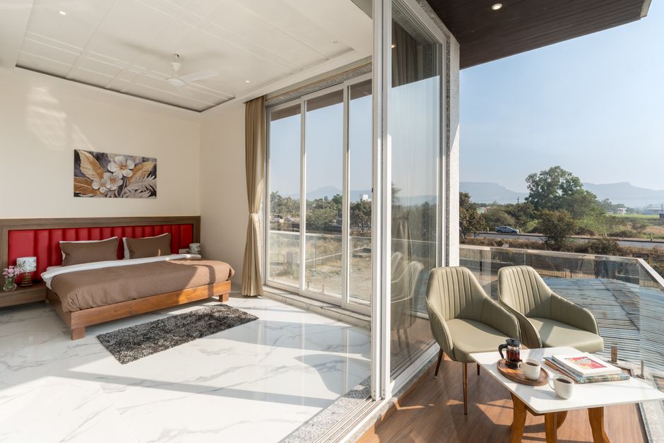 A serene, modern minimalist bedroom featuring a large window that floods the space with natural light, showcasing a calm and restful home sanctuary.